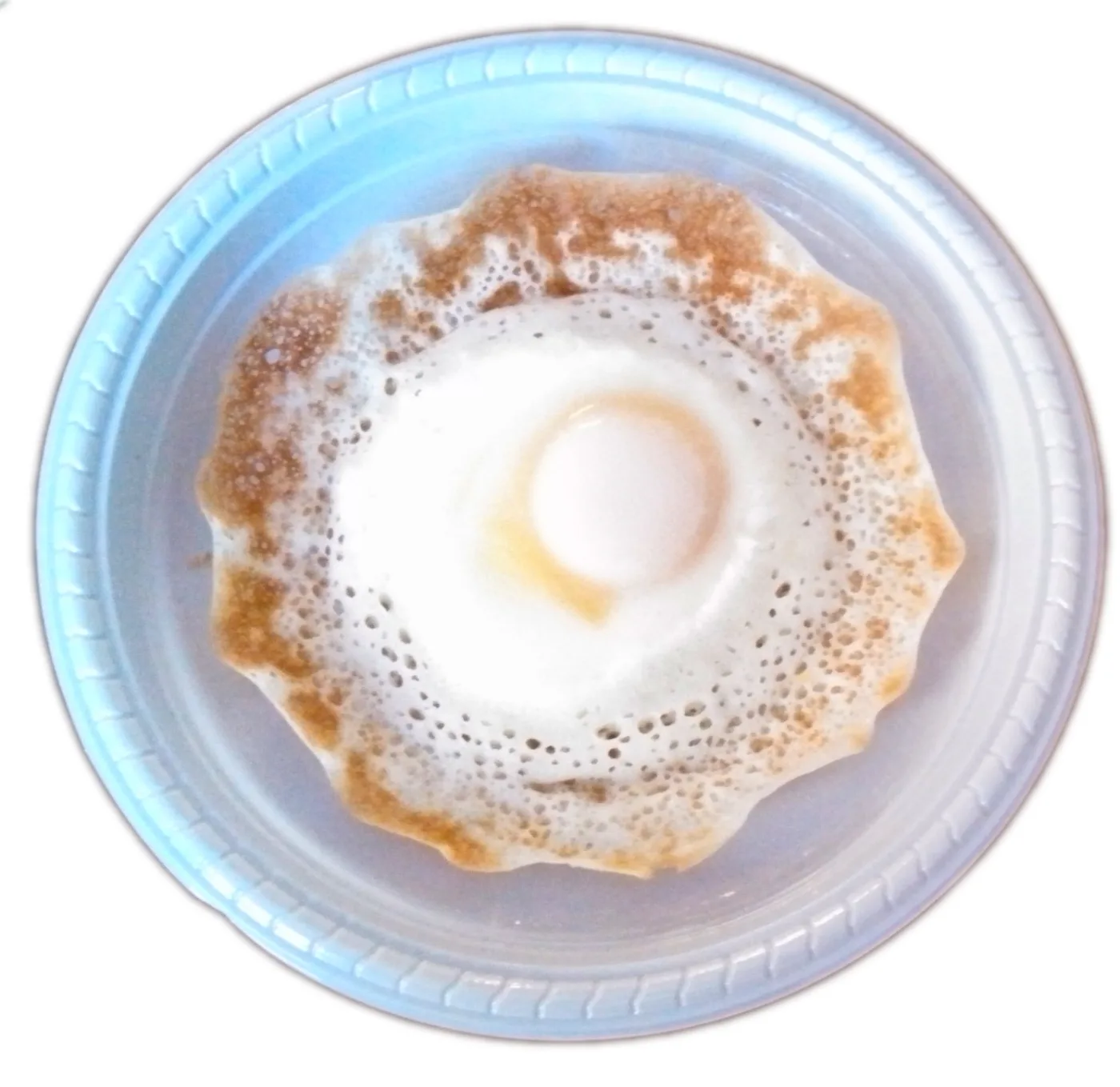Egg hopper — an egg cooked in the centre of the appam.