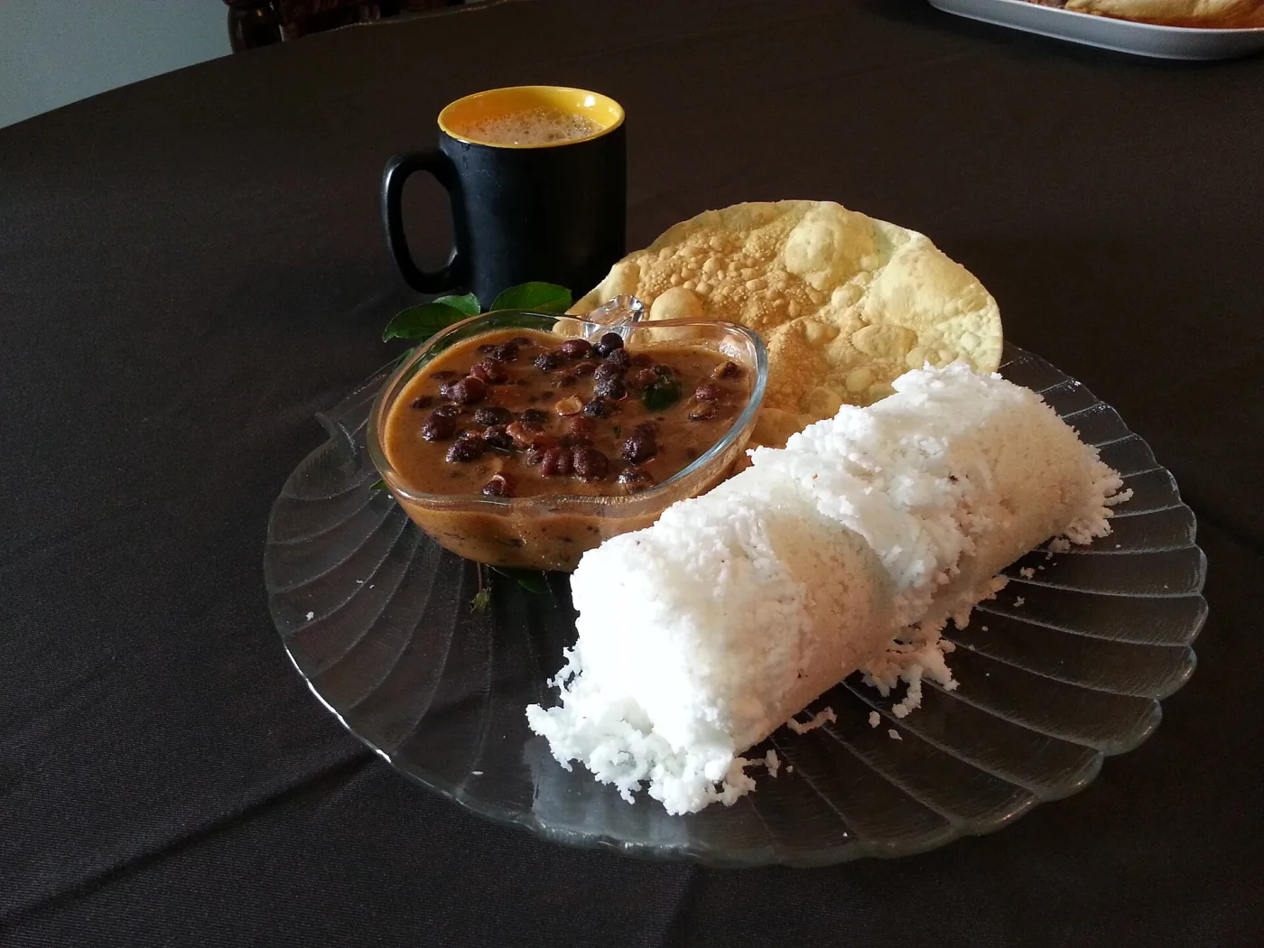 Puttu and kadala with papadam and coffee.