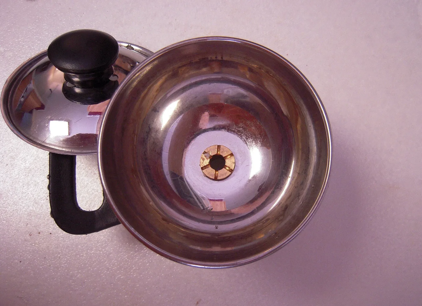 Chiratta puttu steamer — a metal coconut-shell bowl with a perforated base.